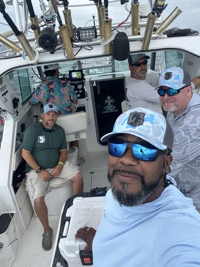 Anglers take a selfie in the cabin of a charter boat.